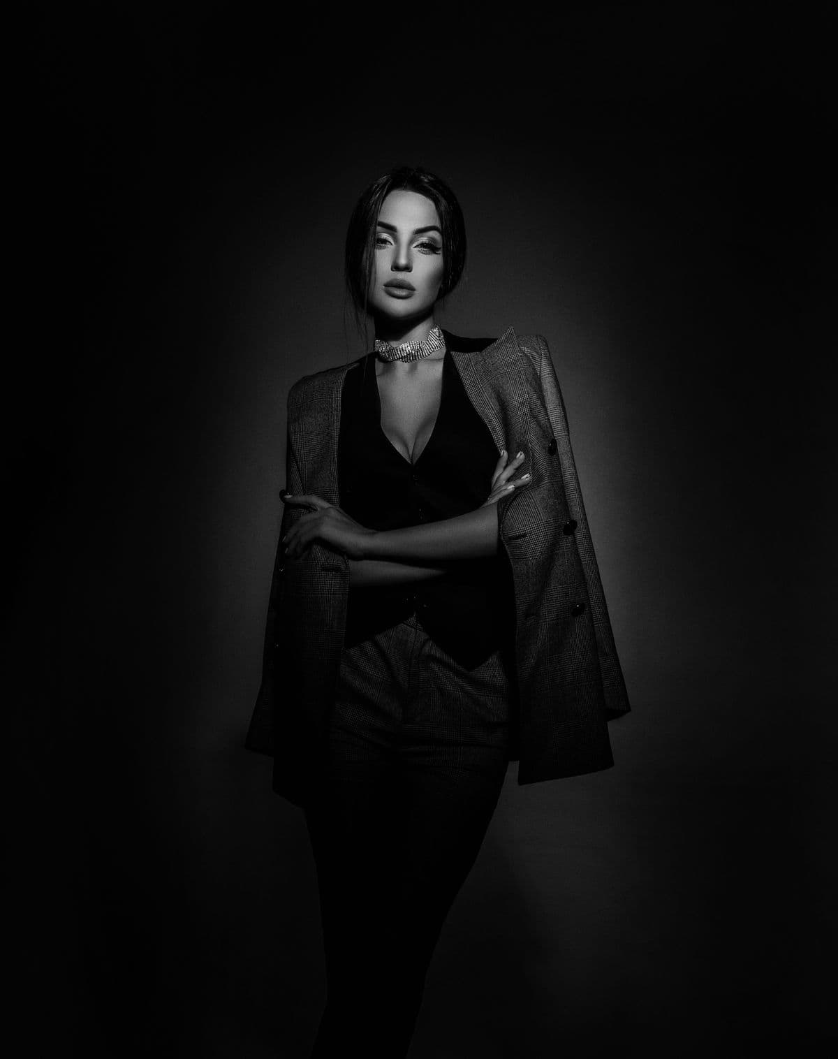 Black and white studio portrait of a woman in a suit jacket